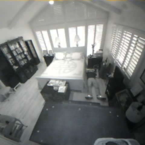 Lightly blurred benchmark Fall scene showing a person down beside a bed